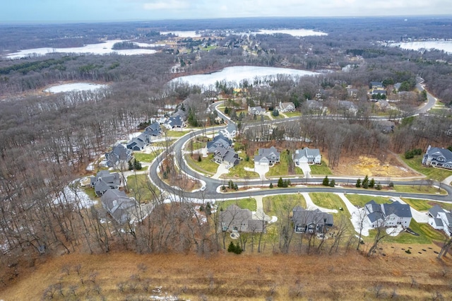 birds eye view of property with a forest view, a water view, and a residential view