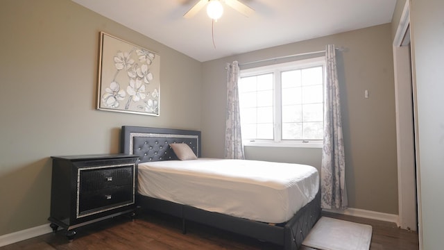 bedroom featuring baseboards, dark wood finished floors, and a ceiling fan