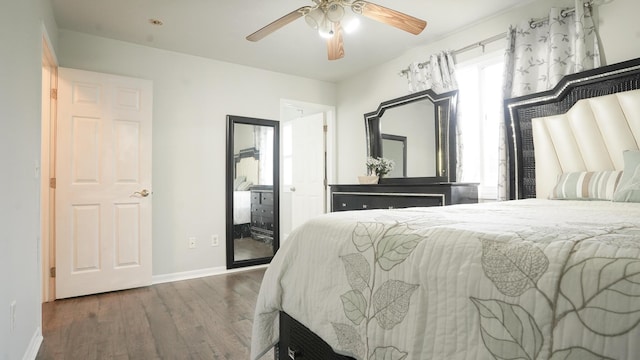 bedroom with ceiling fan, baseboards, and wood finished floors