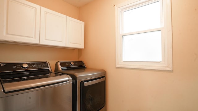 washroom with washer and dryer and cabinet space