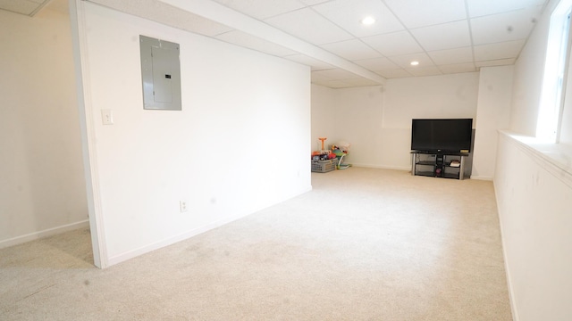 interior space with a drop ceiling, recessed lighting, carpet floors, baseboards, and electric panel