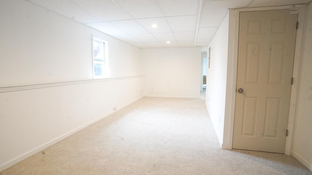 below grade area featuring recessed lighting, baseboards, light carpet, and a drop ceiling