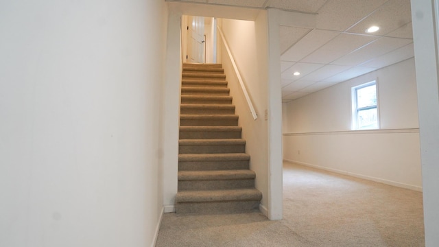 stairway with carpet floors, baseboards, a paneled ceiling, and recessed lighting