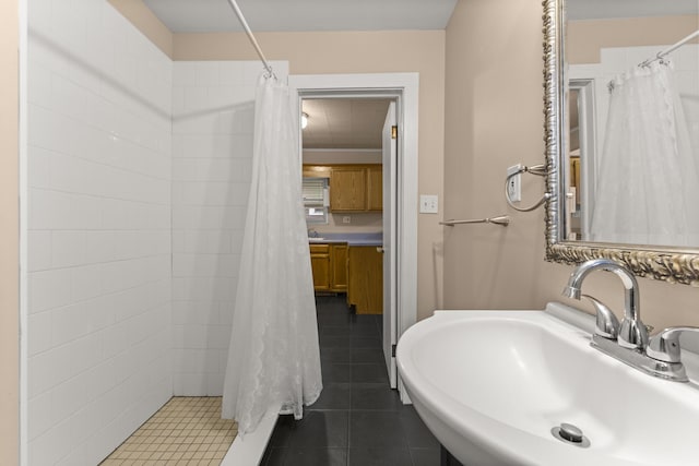 full bath with tile patterned flooring, a sink, and curtained shower