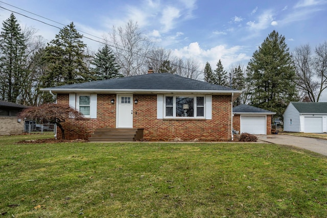 view of front facade with an outbuilding, brick siding, driveway, and a front yard