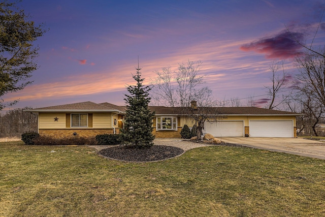 ranch-style home with driveway, an attached garage, and a yard