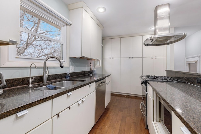 kitchen featuring a sink, dark wood finished floors, white cabinets, appliances with stainless steel finishes, and island exhaust hood