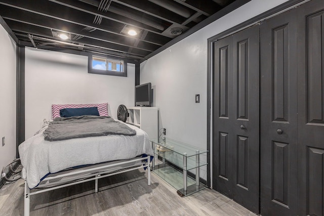 bedroom with visible vents and wood finished floors