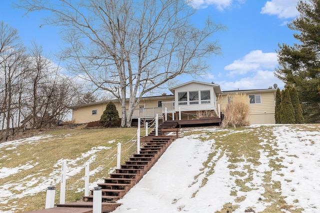 view of front of home featuring stairs and a wooden deck