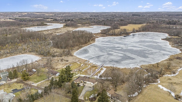 birds eye view of property featuring a view of trees