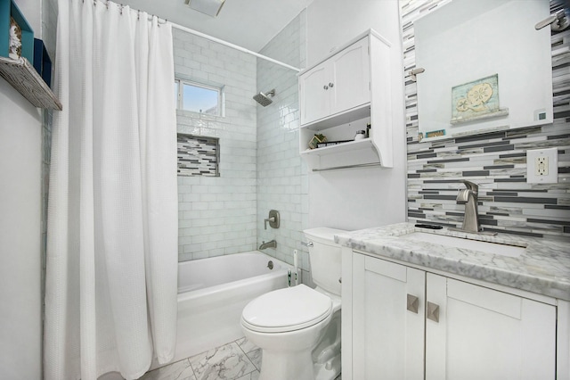 full bath featuring marble finish floor, shower / tub combo with curtain, tasteful backsplash, toilet, and vanity