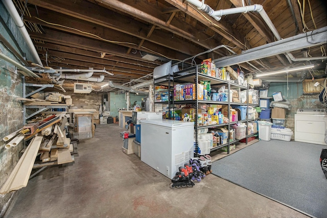 unfinished below grade area with independent washer and dryer and white refrigerator