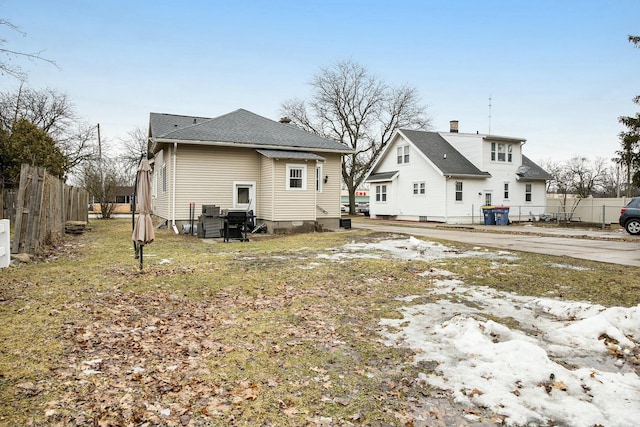 back of house with fence