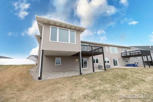 rear view of property with a lawn and a patio