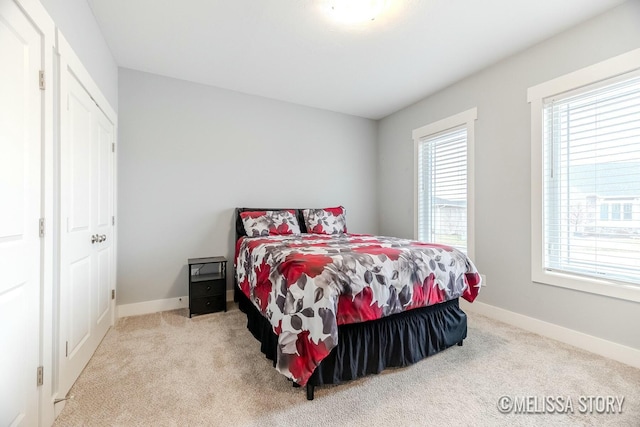 bedroom featuring carpet flooring and baseboards