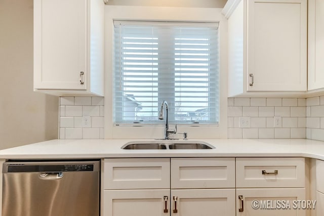 kitchen featuring white cabinetry, a sink, and stainless steel dishwasher