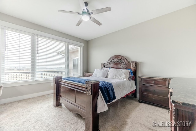 bedroom with baseboards, a ceiling fan, and light colored carpet