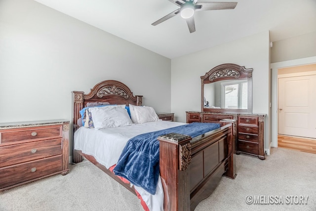 bedroom with a ceiling fan and light colored carpet