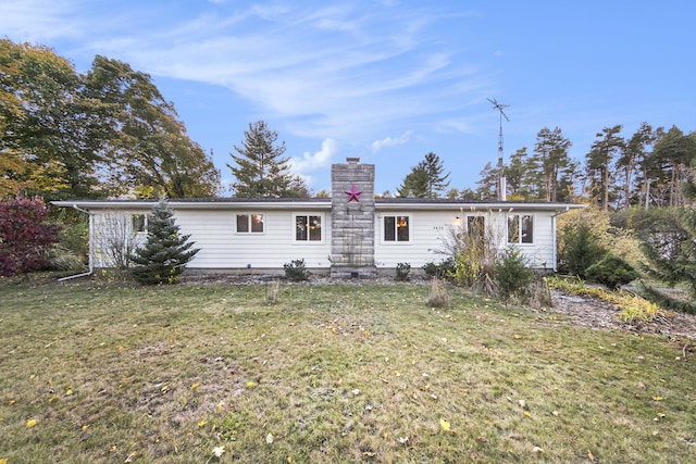 view of front facade featuring a chimney and a front lawn