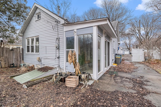 view of home's exterior featuring a gate and fence