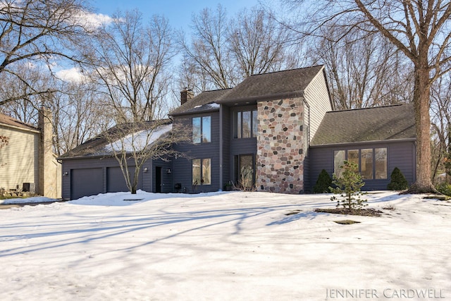 view of front of property with a garage, stone siding, and a chimney