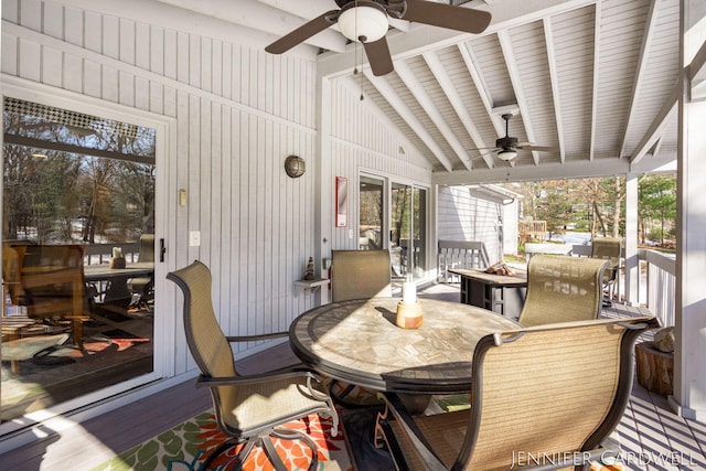 sunroom with a ceiling fan and lofted ceiling with beams