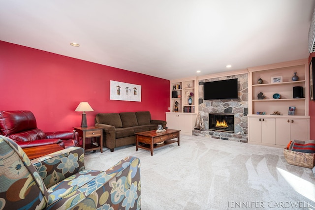 living room with carpet floors, recessed lighting, and a fireplace