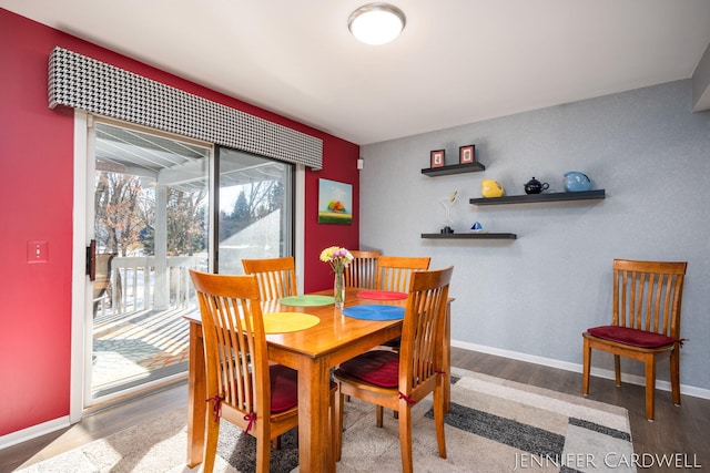 dining area featuring baseboards and wood finished floors