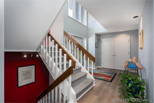 entrance foyer featuring stairway, wood finished floors, and baseboards