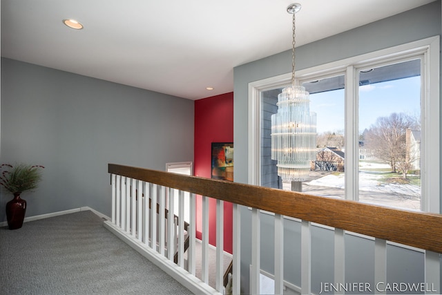 hall with baseboards, an inviting chandelier, carpet, an upstairs landing, and recessed lighting