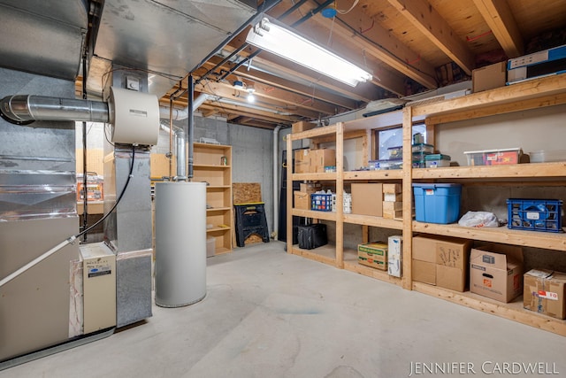 unfinished basement featuring gas water heater and heating unit