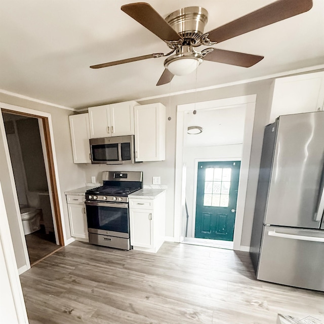 kitchen featuring light wood-style floors, white cabinetry, and stainless steel appliances