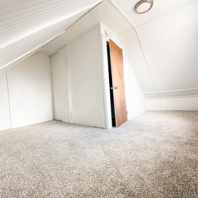 bonus room featuring lofted ceiling and carpet flooring