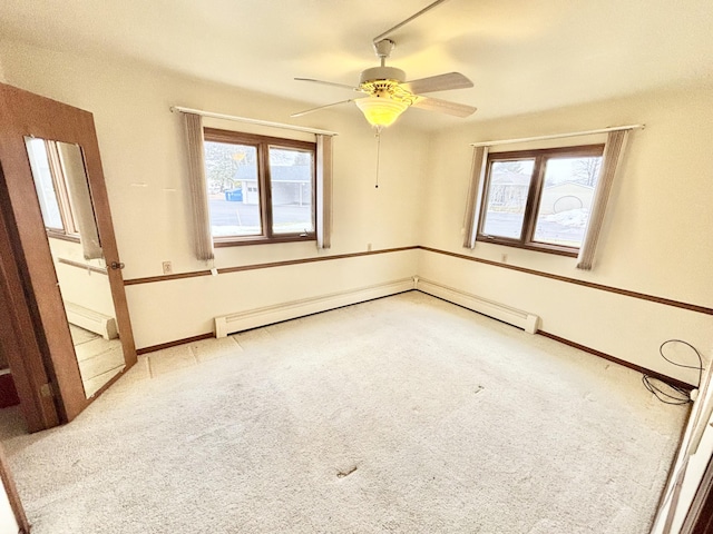 empty room with a wealth of natural light, baseboards, and carpet