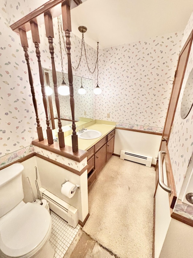 bathroom featuring a baseboard radiator, vanity, toilet, and wallpapered walls