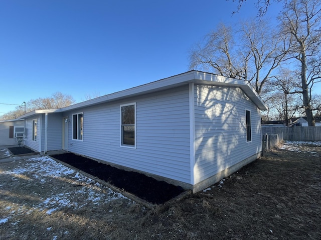 view of home's exterior with fence