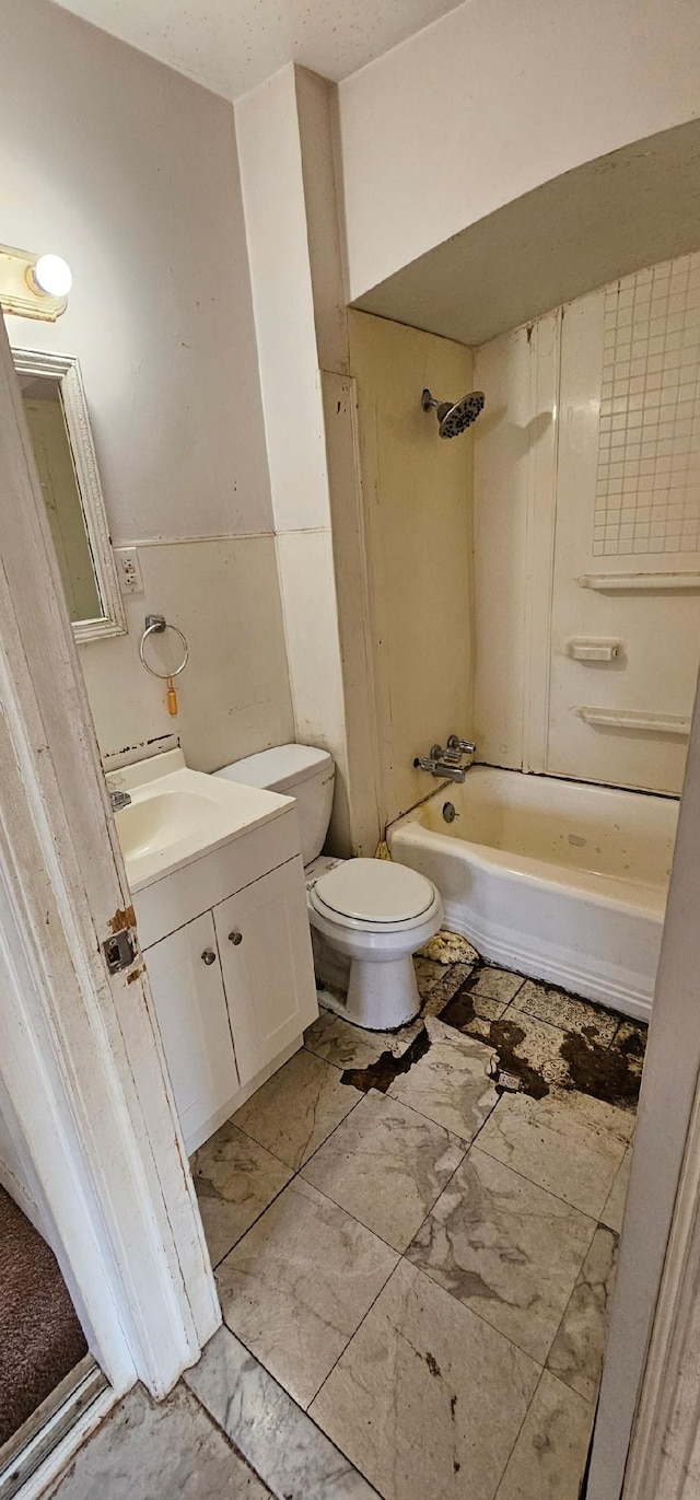 bathroom with marble finish floor, shower / bath combination, vanity, and toilet