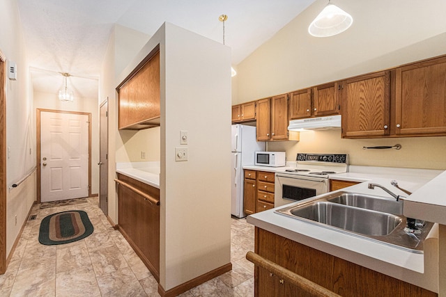 kitchen featuring brown cabinetry, white appliances, a sink, and under cabinet range hood