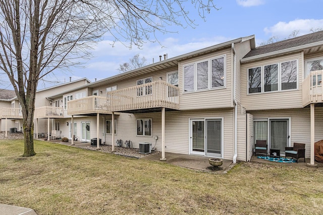 back of house with a patio area, central AC unit, and a yard