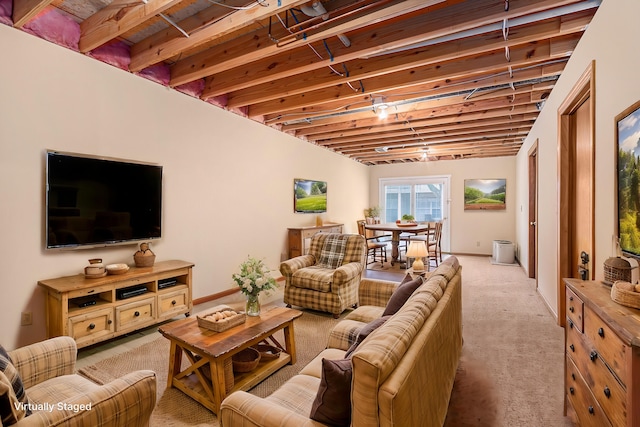 living area featuring baseboards and light colored carpet