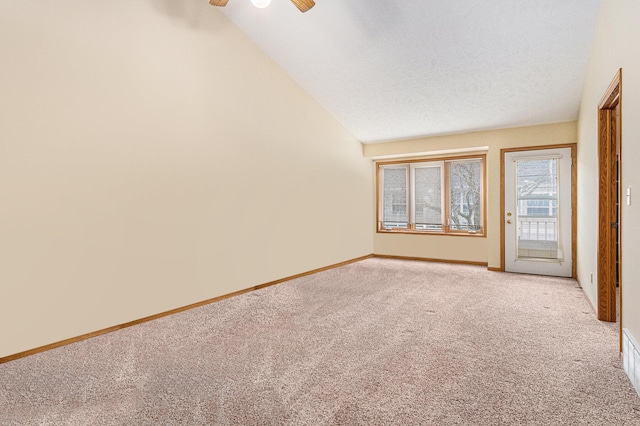 unfurnished room with light carpet, baseboards, lofted ceiling, ceiling fan, and a textured ceiling