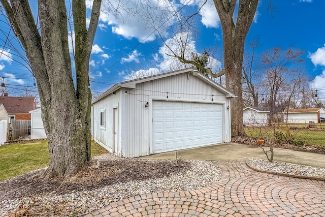 detached garage featuring fence