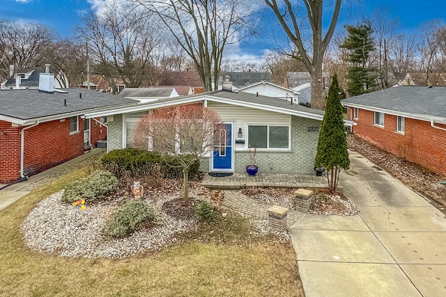 view of front of property featuring brick siding and driveway