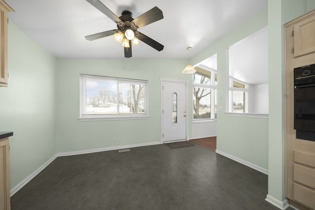 entrance foyer with baseboards, lofted ceiling, and ceiling fan