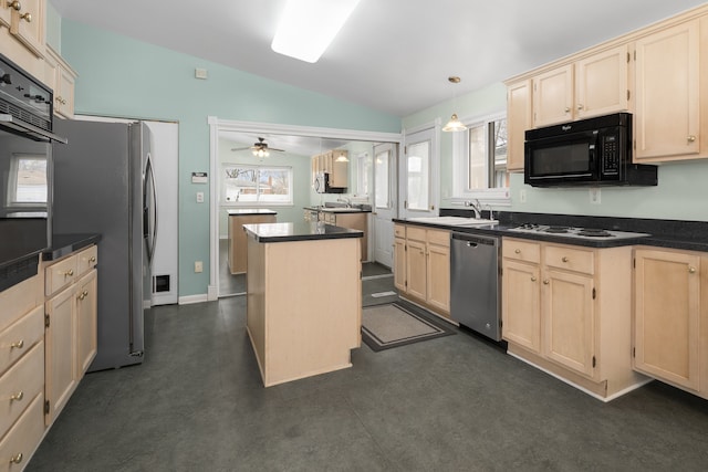 kitchen with a sink, black appliances, light brown cabinets, and vaulted ceiling