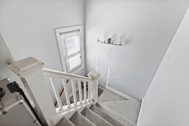 stairs with baseboards and carpet floors