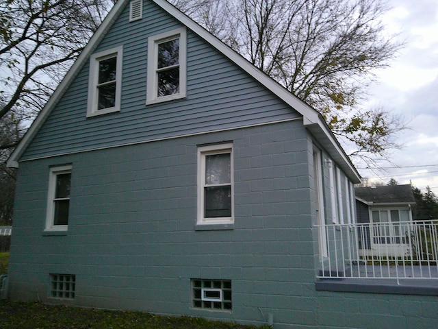 view of side of property featuring concrete block siding