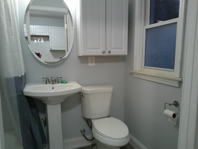 full bath with baseboards, backsplash, and toilet