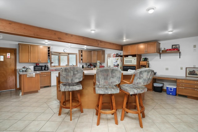 kitchen with brown cabinets, black appliances, open shelves, and built in study area