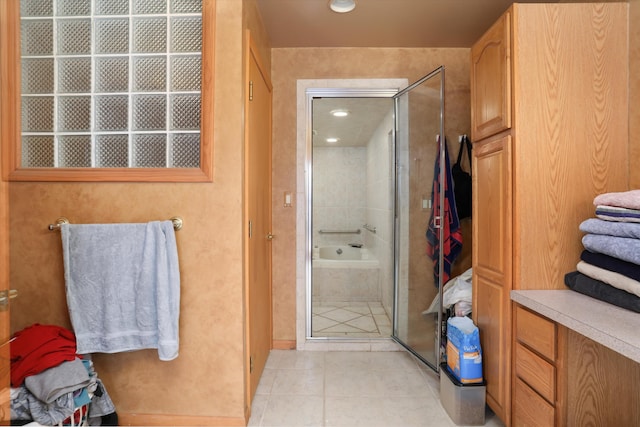 bathroom with tile patterned flooring and a shower stall